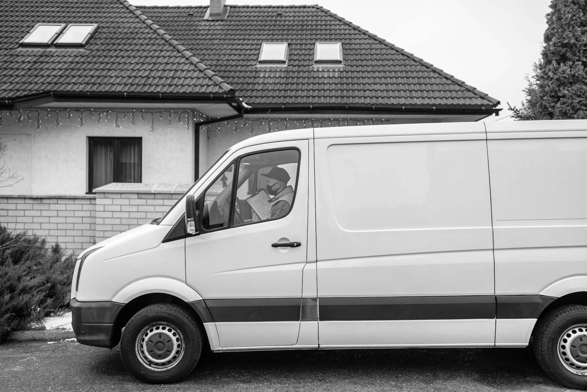 A plumber's van parked at a kerbside in a UK residential street